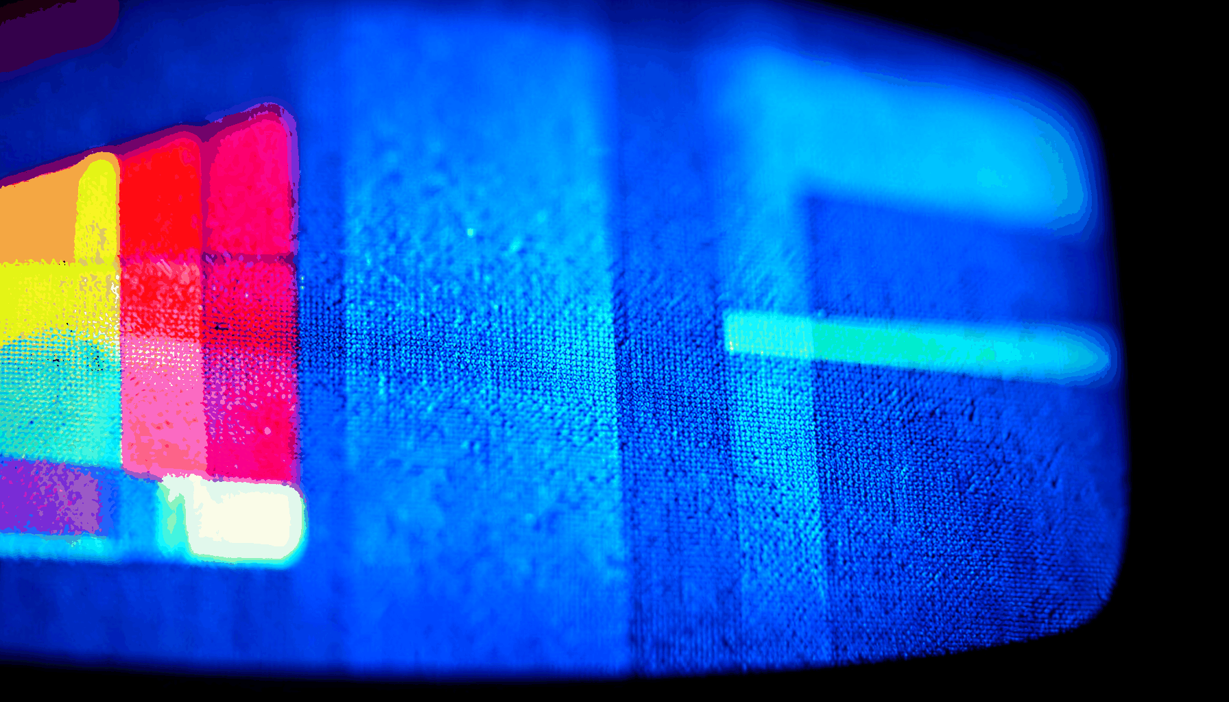 Television screen displaying vibrant color bars and broadcast signal pattern